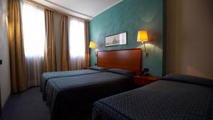 A bed or beds in a room at Classic Hotel Tulipano