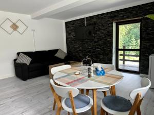 a living room with a table and chairs at Forest Apart in Predeal