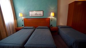 A bed or beds in a room at Classic Hotel Tulipano