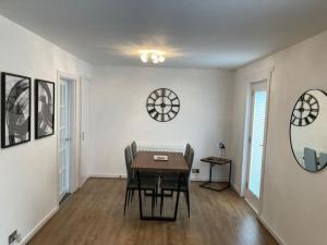 a dining room with a table and chairs and a mirror at Haymons Cove in Eyemouth