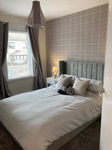 a bedroom with a bed with a teddy bear on it at Haymons Cove in Eyemouth