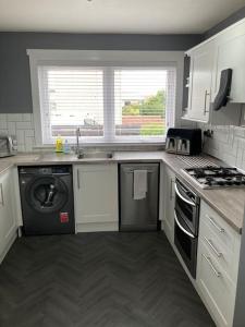 a kitchen with a sink and a dishwasher at Haymons Cove in Eyemouth