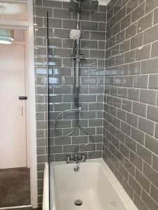 a bathroom with a bath tub with a shower at Haymons Cove in Eyemouth