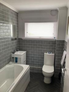 a bathroom with a tub and a toilet and a sink at Haymons Cove in Eyemouth