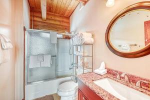 a bathroom with a toilet and a sink and a mirror at Spectacular Chalet overlooking the ski slopes in Brian Head