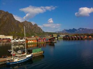 a boat is docked at a dock in the water at Stamsund Authentic Rorbu in Stamsund