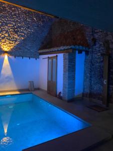 a swimming pool in a villa at night at Beni Qásim 1915 in Benicàssim