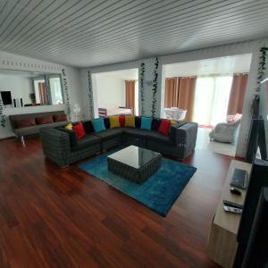 Pacific Lodge في Mahina: غرفة معيشة مع أريكة وطاولة