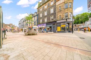 an empty street in a city with buildings at Stylish 4 Bed-Town Centre in Galashiels