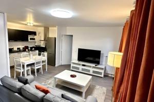 a living room with a couch and a table at Appartement Cozy - Quartier résidentiel in Melun
