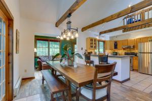a kitchen and dining room with a wooden table and chairs at Milanville Cabin with Fire Pit, 1 Mi to River! 