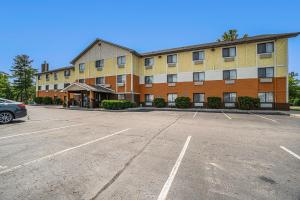 an empty parking lot in front of a building at Days Inn & Suites by Wyndham Traverse City in Traverse City