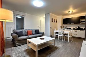 a living room with a couch and a table at Appartement Cozy - Quartier résidentiel in Melun
