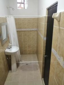 a bathroom with a sink and a shower with a toilet at HOSTEL M&H in Cartagena de Indias