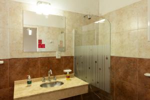 a bathroom with a sink and a mirror at El Amparo Hotel in San Luis