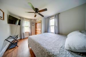 a bedroom with a bed and a ceiling fan at Central Erie Vacation Rental about 2 Mi to Beach! in Erie