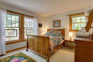 a bedroom with a bed and a desk and windows at Tannersville Vacation Rental with Pool Table! in Tannersville
