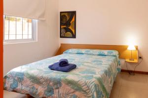 a bedroom with a bed with a towel on it at El Amparo Hotel in San Luis