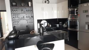 a black and white kitchen with a counter and a refrigerator at Apartament nad jeziorem w Brodnicy in Brodnica