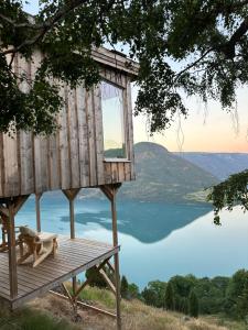 a tree house with a view of a lake at Raaum Gard, hytte 2 in Hafslo
