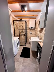 a bathroom with a shower and a toilet and a sink at Zatoka Kalwa in Pasym +23 photos