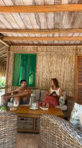 a man and a woman sitting on a couch at Reserva Natural El Matuy in Palomino