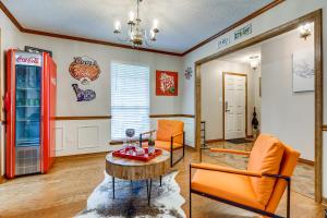 a living room with a coke machine and a table and chairs at Dog-Friendly Alabama Retreat with Patio and Fire Pit! in Semmes