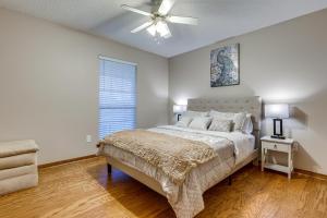 a bedroom with a bed and a ceiling fan at Dog-Friendly Alabama Retreat with Patio and Fire Pit! in Semmes