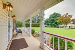 a porch with a chair and a view of a yard at Dog-Friendly Alabama Retreat with Patio and Fire Pit! in Semmes