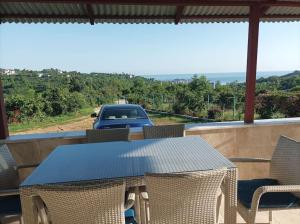 a table and chairs on a balcony with a truck at Denize 3km Daire - Piraziz Giresun in Giresun