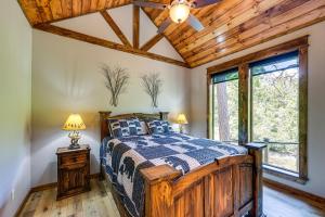a bedroom with a bed with a wooden ceiling at Big Cedar Vacation Rental with Deck and Hot Tub! in Hodgen