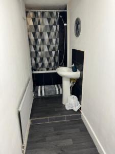 a small bathroom with a sink and a shower at Central London location, close to bars restaurants and train stations in London