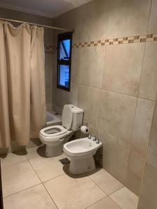 uma casa de banho com um WC branco e uma janela em Departamento céntrico amueblado - 4 personas em Concordia