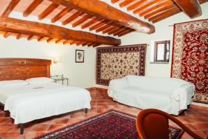 two beds in a room with wooden ceilings at COUNTRY HOUSE LE VIGNE b&b in Galluccio