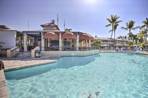 a large swimming pool in front of a resort at Kona Coast Resort Condo Oceanfront Property! in Kailua-Kona