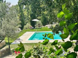 a person sitting in a chair next to a swimming pool at Terrematte turismo e natura in Polizzi Generosa