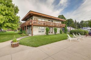 a house with a deck and chairs in the yard at Canandaigua Lake Romantic Getaway with Boat Slip! in Rushville
