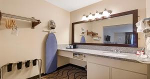 a bathroom with a sink and a large mirror at SureStay Plus Hotel by Best Western Sacramento North in Sacramento