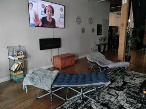 a living room with a couch and a tv at Idlewild Villa Loft apts in Detroit