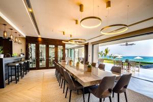 an open dining room with a long table and chairs at Sunny Vacation Villa No 38 in San Rafael del Yuma