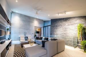 a living room with a couch and a brick wall at Sunny Vacation Villa No 38 in San Rafael del Yuma