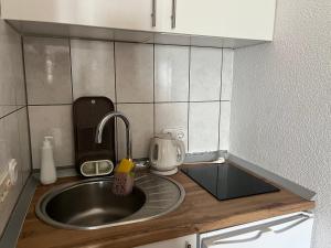 a kitchen with a sink and a counter top at Apartmani Sunset in Neum +19 photos