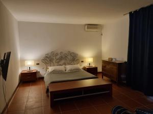 una camera con un letto e due comodini di Villa Sul Molo tra Siracusa e Catania ad Augusta