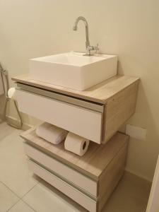 uma casa de banho com um lavatório e 2 rolos de papel higiénico em Villa Ida, Suíte 01 c/ copa p/ casal em Serra Negra