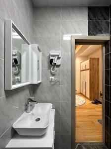 a bathroom with a sink and a mirror at Dushanbe City View Apartments in Dushanbe