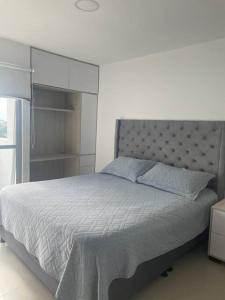 ein Schlafzimmer mit einem großen Bett und einem Schrank in der Unterkunft Altavista Apartamento Lindo y Comodo Piso 8 en Pereira in Pereira