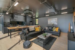 a living room with a couch and a table at Panorama Vista in Pauanui