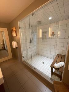 a large bathroom with a shower with a glass door at Lake House at Quails' Gate Winery in West Kelowna