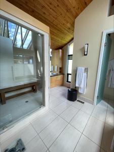 a bathroom with a shower and a large window at Lake House at Quails' Gate Winery in West Kelowna