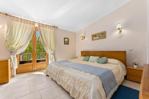 a bedroom with a large bed and a balcony at The Quinta Bio Pool, Swimming Pool, 3 Bedroom ensuites Villa in Almancil +30 photos